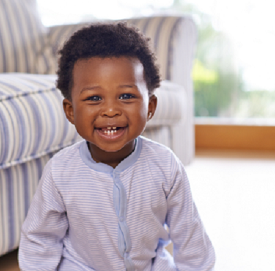 African American smiling baby in lavender striped romper.