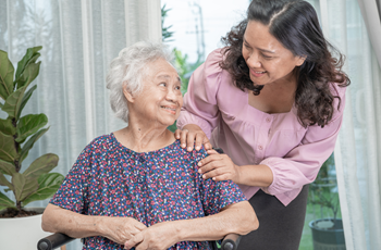 Younger and older Asian American women indoors.