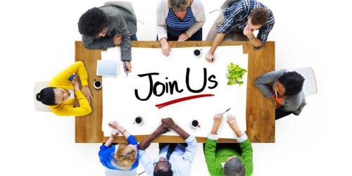 image_aerial shot of people around table with Join Us on poster